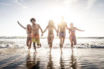 Friends running on the beach