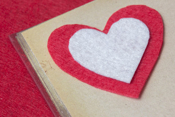 Red felt heart on the book