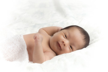 Fototapeta na wymiar Little asia newborn baby boy 15 days lying on a bed