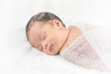 Fototapeta na wymiar Little asia newborn baby boy 15 days lying on a bed sleeping wit