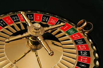two gold wedding rings on the roulette wheel