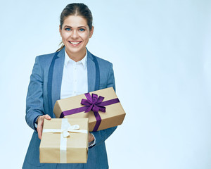 Young business woman standing with gift box against white backgr