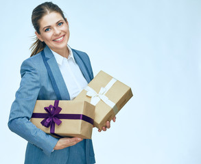 Young business woman standing with gift box against white backgr
