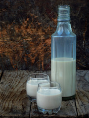 Irish coffee cream liqueur Baileys in glass and botle on wooden background. Selective focus. Copy space