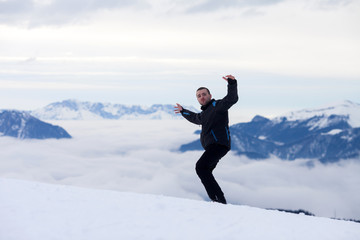 Young skier, enjoying the view from top of mountains in Austrian