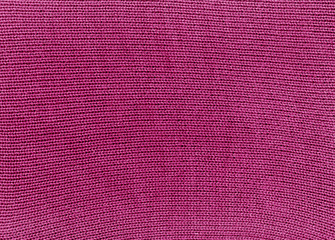 Fototapeta premium Pink knitted material texture.