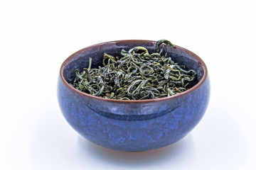 Fototapeta premium Chinese Green tea. (Huang Shan Mao Feng) in a blue ceramic bowl