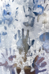 handprint on the frozen ice window