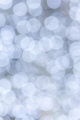 Abstract background blurred white bokeh circles.