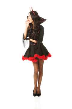 Full length woman wearing devil clothes whispering to someone