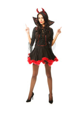 Portrait of a woman wearing devil clothes pointing up with both hands