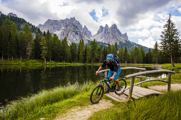 Fototapeta premium Mountain biking in the Dolomites, Misurina, Italy. Tre Cime di L