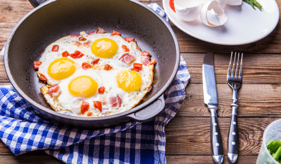 Fred eggs in pan with tomatoes.