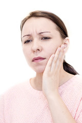 Closeup of young woman suffering from toothache at home. Terrible Strong Teeth Pain, Touching Cheek With Hand. Female Feeling. Dental Care And Health Concept.