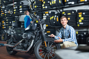 Portrait of customer choosing new motorbike in workshop