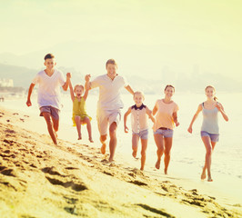 Big family running on beach