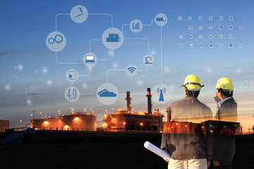 two engineer on site , Industry 4.0 concept image.Oil refinery at twilight with cyber and physical...