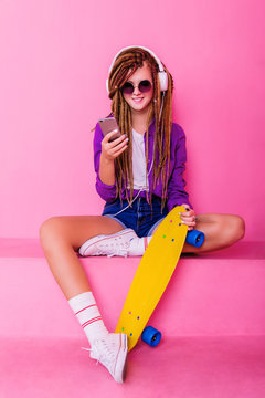Portrait of a young girl with skateboard