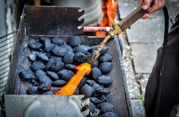Firing up charcoal briquettes for the BBQ grill.