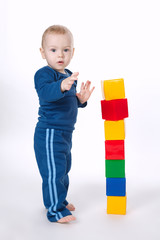 boy plays with cubes on white