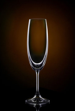 Empty wine glass on dark red