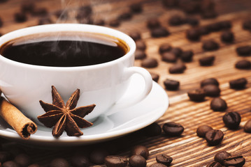 cup of coffee drink with cinnamon sticks and star anise