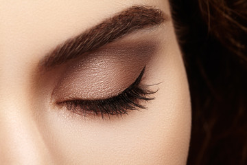 Close-up macro of beautiful female eye with perfect shape eyebrows. Clean skin, fashion naturel...