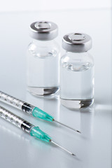 medical ampoules and syringe on White background