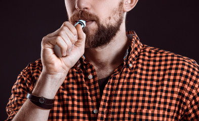 young man smoking electronic cigarette