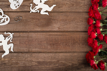 Red roses bouquet over wooden table. Top view with copy space. flowers