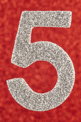 Number five silver color over a red background. Anniversary.