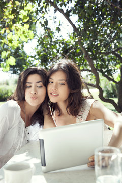 Young women taking selfie with digital tablet