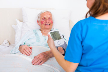 Obraz premium Caretaker measuring blood pressure