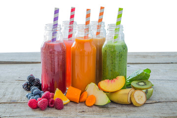Selection of colourful smoothies on rustic wood background