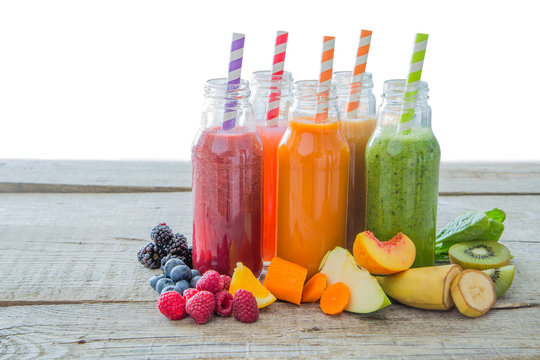 Selection of colourful smoothies on rustic wood background