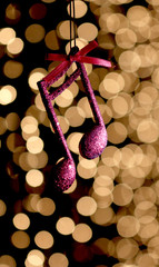 cristmas music note decoration in front of a bokeh lights