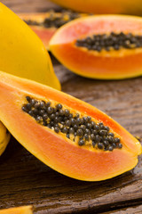 Sliced fresh papaya on wooden background