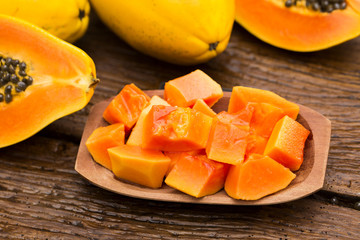 Sliced fresh papaya on wooden background