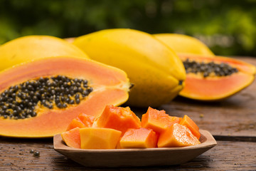 Sliced fresh papaya on wooden background