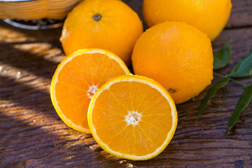 Sweet fresh oranges in natural light on old wood
