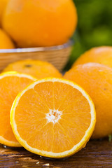 Sweet fresh oranges in natural light on old wood