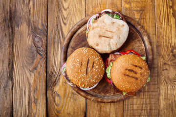 Classic american burgers, fast food on wood background