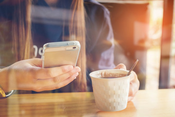 woman using on mobile phone during rest in coffee shop