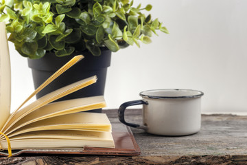 Old vintage books, cup of tea, cake and keys on rustic wooden table