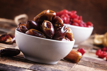 Dried sweet dates. Vintage wooden background, selective focus