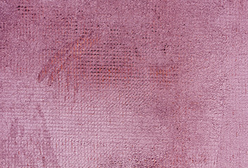 Weathered pink color cement wall surface.