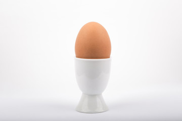 Egg in a egg cup on a white background