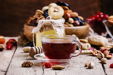 Middle East black tea in a cup with dried fruits and nuts. Vinta
