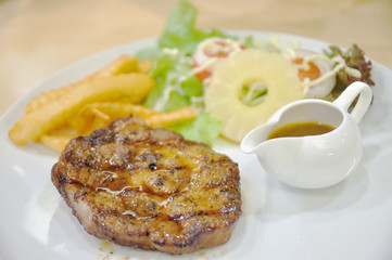 Pork steak with salad fruit and chip and gravy sauce