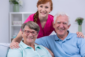 Elderly couple and caregiver